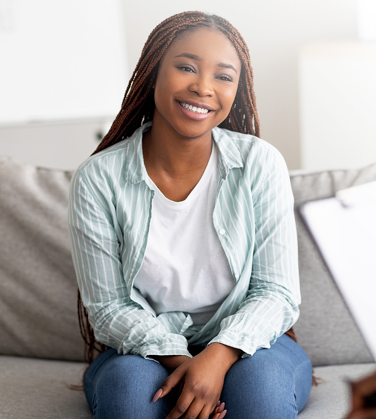 Smiling woman sitting on a couch.