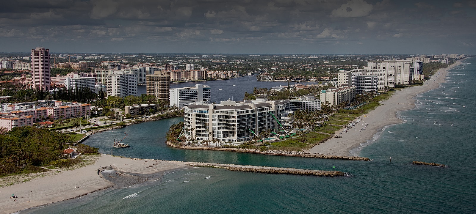 Coastal cityscape with buildings and waterways.